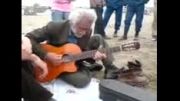پیرمرد گیتاریست با عشق می نوازد